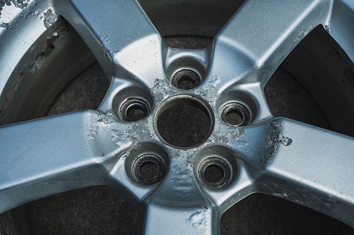 corrosive metal failure known as filiform corrosion seen on a tire rim
